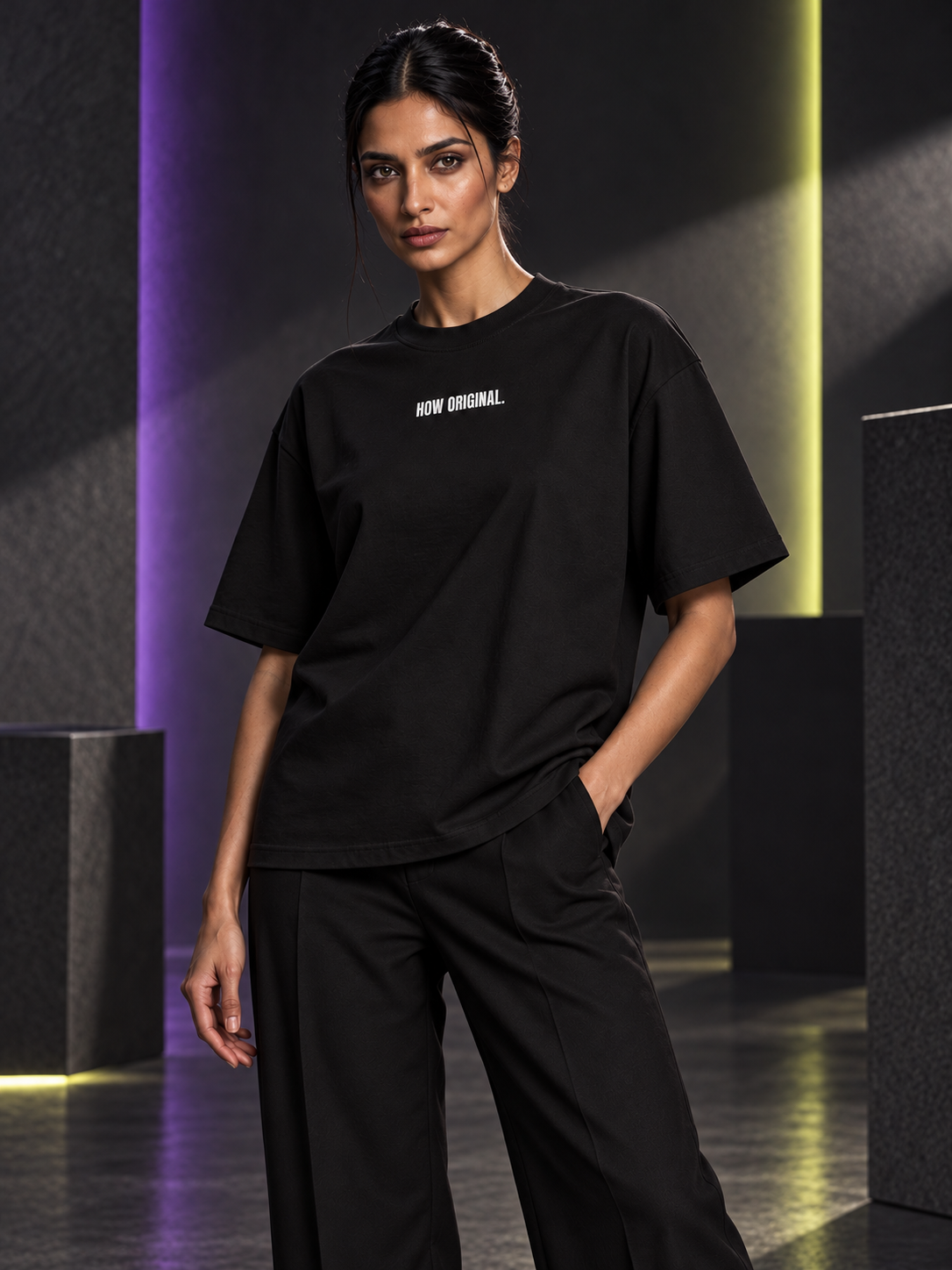 WRYKIND editorial — Magazine-style AI styling image of a female model posing in the HOW ORIGINAL. black tee