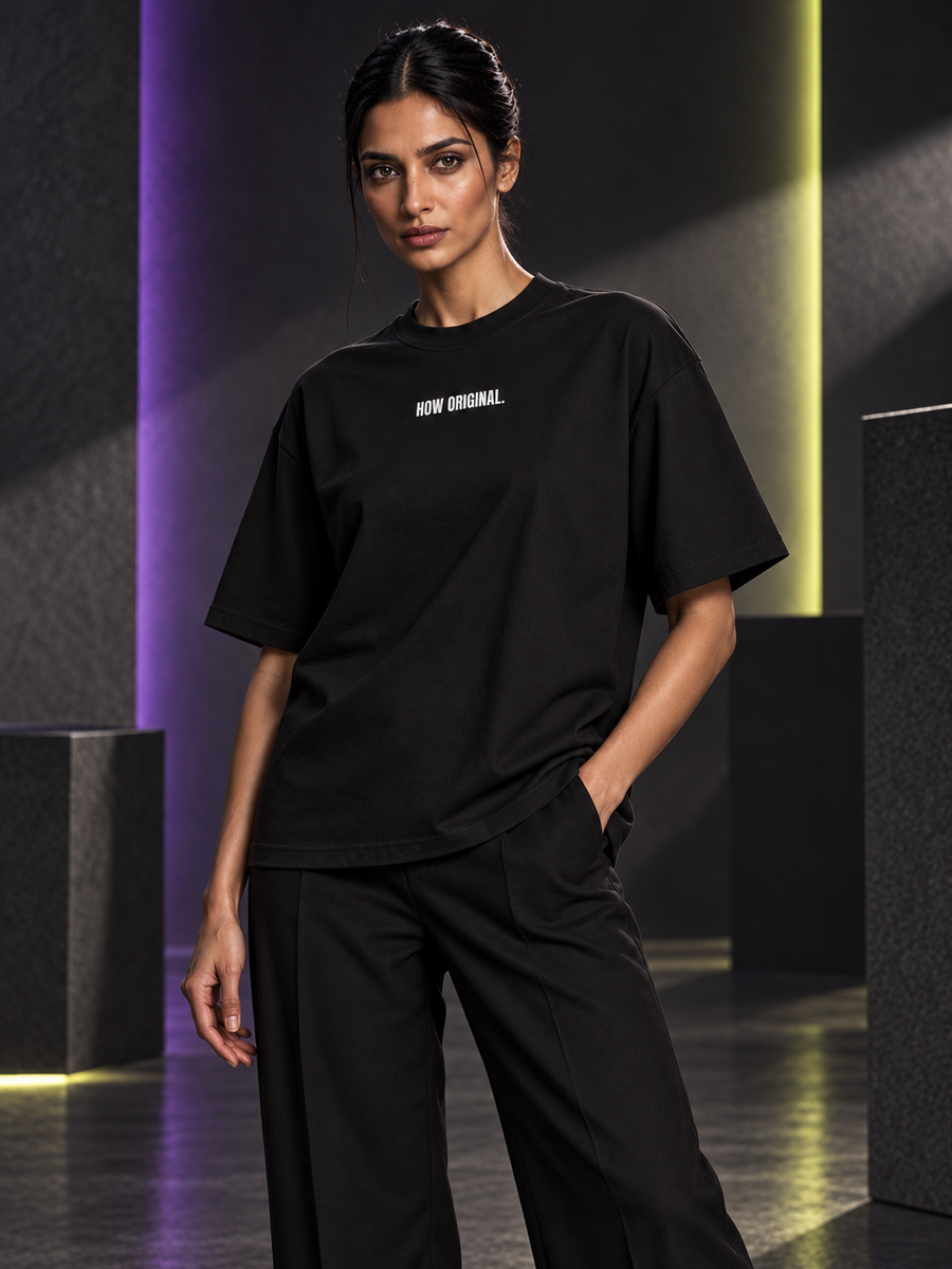 WRYKIND editorial — Magazine-style AI styling image of a female model posing in the HOW ORIGINAL. black tee
