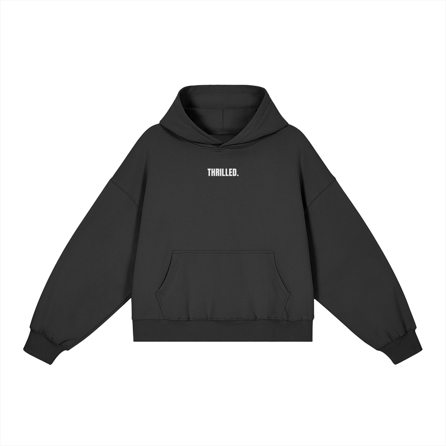 THRILLED. black boxy hoodie with compact white lettering centered on the upper chest